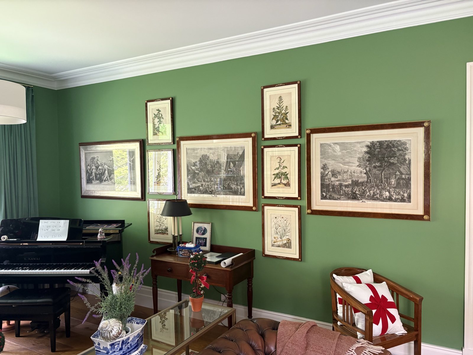 Gallery wall of framed prints on green feature wall, Top Notch Handyman Service