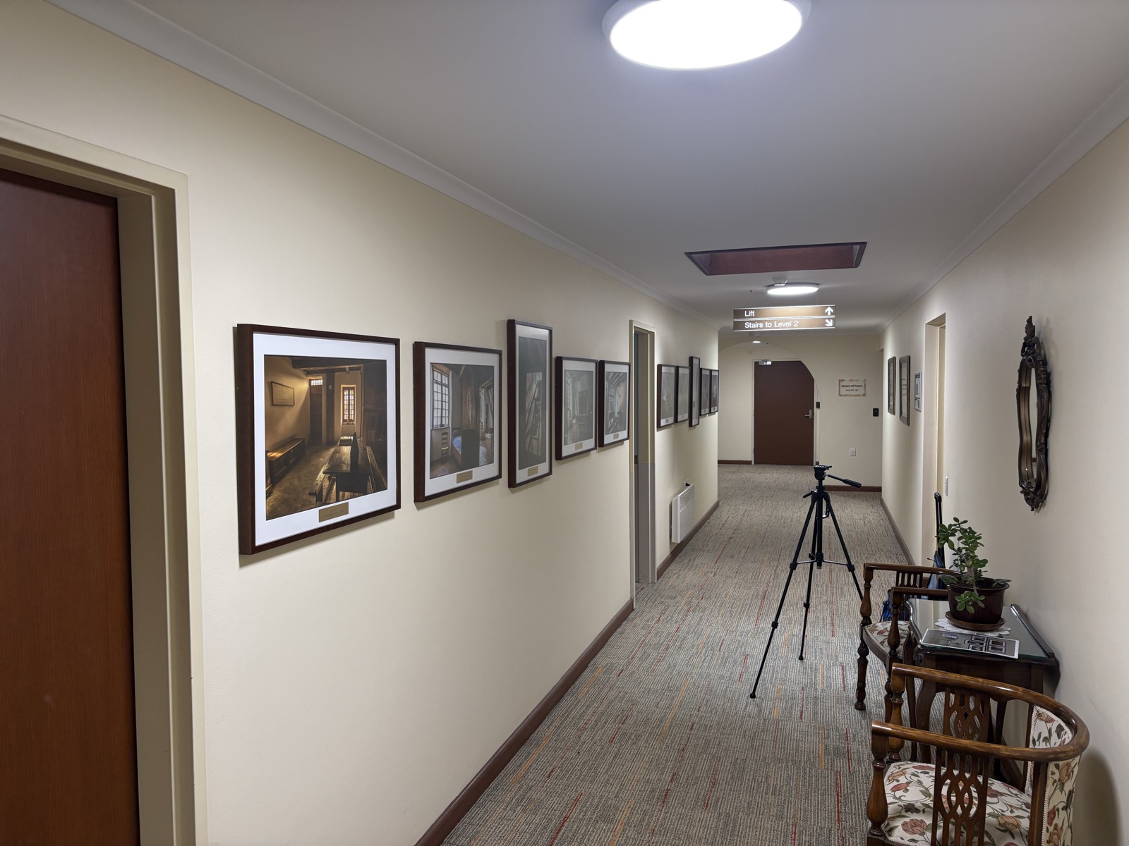 Framed artworks hung along corridor wall, Top Notch Handyman Service