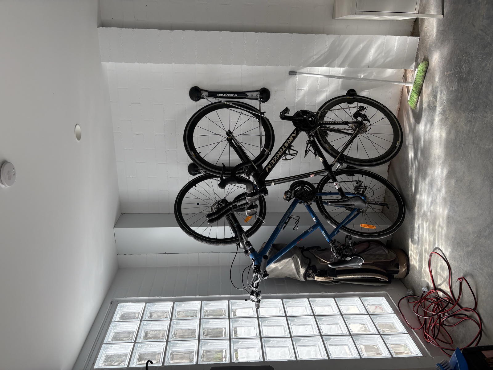 Bikes mounted on wall rack in garage, Top Notch Handyman Service