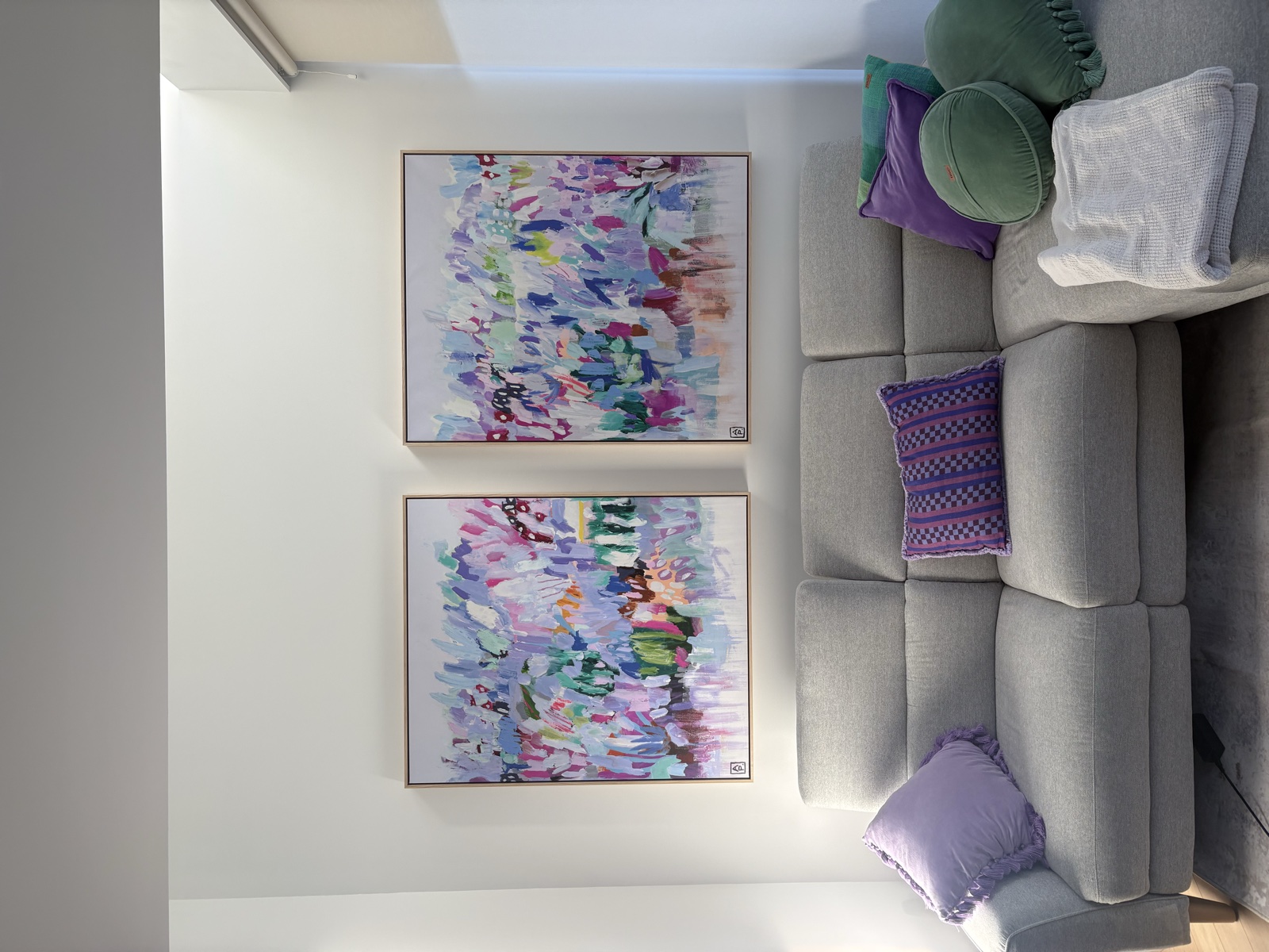Pair of artworks hung in living room, Top Notch Handyman Service