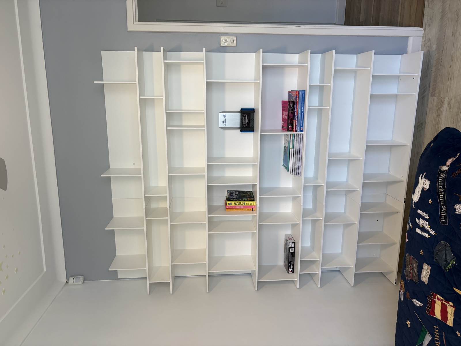 Custom white shelving unit installed in bedroom, Top Notch Handyman Service